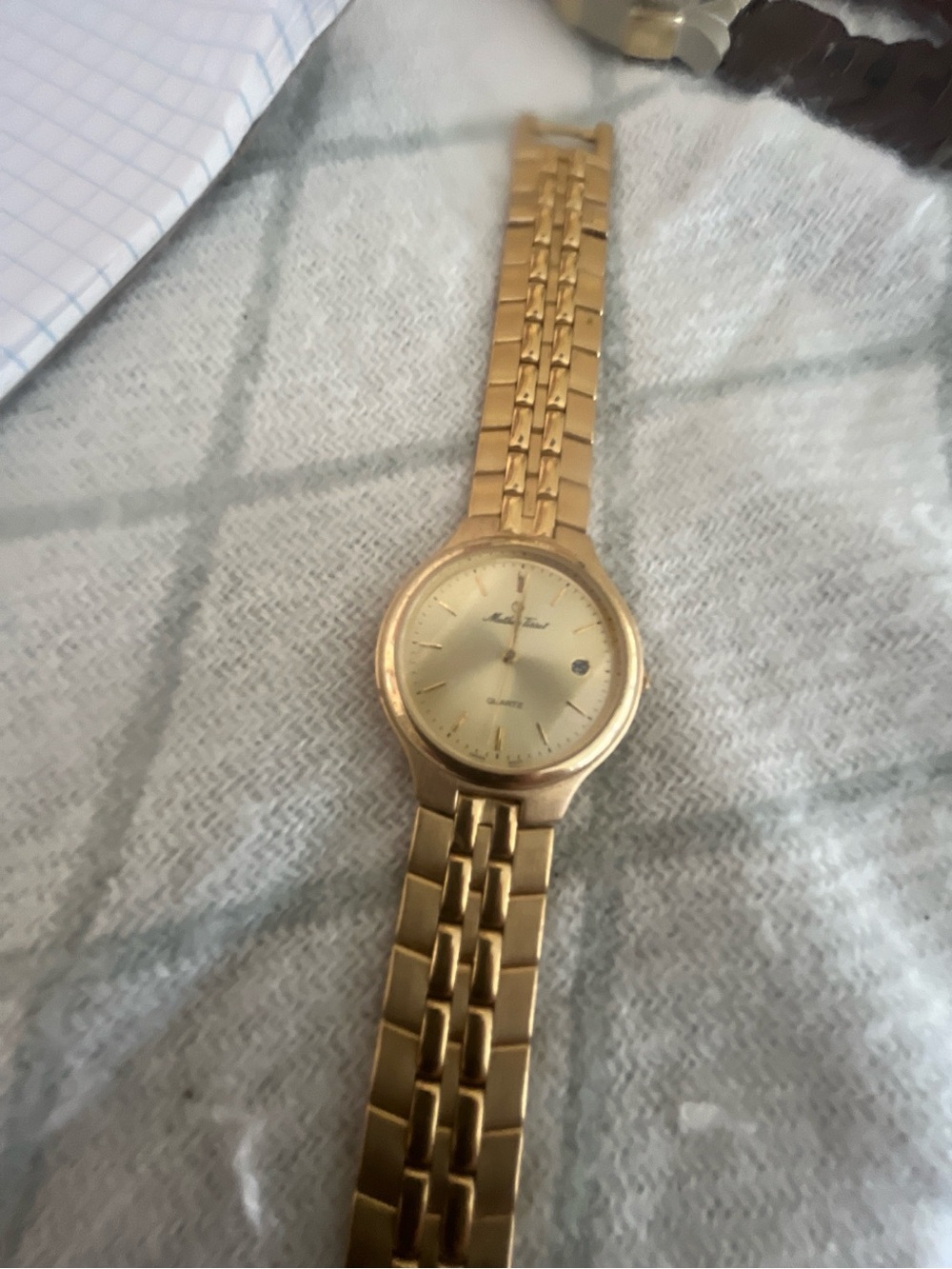 Vintage Mathey Tissot quartz watch with date window at 3 o’clock in gold tones.